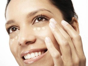 Woman applying concealer