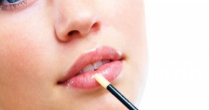 Stock-photo-of-woman-applying-lipgloss