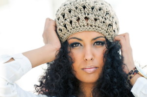 Portrait of young black woman wearing wool cap